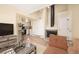 Bright living area showcasing a fireplace, and seamless access to the kitchen at 17093 E Tennessee Dr # 211, Aurora, CO 80017
