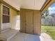 Covered back porch featuring door and built in storage, with yard views at 235 S Stuart St, Denver, CO 80219