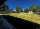 Expansive backyard featuring a lush lawn, privacy fence and storage shed at 235 S Stuart St, Denver, CO 80219