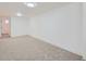 Finished basement with neutral carpet, trim and white walls at 235 S Stuart St, Denver, CO 80219