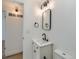 Updated bathroom with new vanity, mirror, light fixture, and black faucet at 235 S Stuart St, Denver, CO 80219