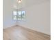 Bedroom features light wood floors, a window and base trim at 235 S Stuart St, Denver, CO 80219
