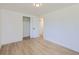 Bedroom with light wood flooring and neutral paint, and a closet with bifold doors at 235 S Stuart St, Denver, CO 80219