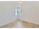 Bright bedroom featuring light wood flooring and large windows at 235 S Stuart St, Denver, CO 80219