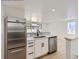 Bright kitchen features stainless steel appliances, white cabinets, and sleek countertops at 235 S Stuart St, Denver, CO 80219
