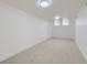 Large living room with ample natural light, carpeted floors, and neutral walls at 235 S Stuart St, Denver, CO 80219