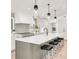Modern kitchen boasts a large center island with seating and professional grade appliances at 4930 E Ellsworth Ave, Denver, CO 80246