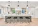 Contemporary kitchen showcasing oversized island with pendant lighting and breakfast bar stools at 4930 E Ellsworth Ave, Denver, CO 80246