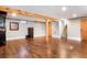 Spacious basement with wooden floors and support beams at 2254 S Eagle St, Aurora, CO 80014