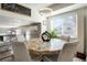 Bright dining area features a unique stone table, modern lighting, and large windows at 2254 S Eagle St, Aurora, CO 80014