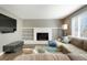 Cozy living room featuring a fireplace, built-in shelving, and comfortable seating at 2254 S Eagle St, Aurora, CO 80014