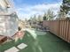 Beautifully landscaped backyard with a putting green, mature trees, fencing and storage shed at 6686 Solana Dr, Castle Pines, CO 80108