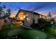 Picturesque backyard featuring a putting green, patio, and shed under a vibrant evening sky at 6686 Solana Dr, Castle Pines, CO 80108