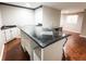 Basement bar area featuring a modern countertop, ample storage, and stylish flooring at 6686 Solana Dr, Castle Pines, CO 80108