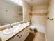 Well-lit bathroom featuring a double sink vanity with decorative tile and a shower/tub combo with matching tile at 6686 Solana Dr, Castle Pines, CO 80108