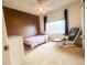 Cozy bedroom featuring a bed, chair, and window overlooking the outdoor scenery at 6686 Solana Dr, Castle Pines, CO 80108