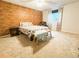 Cozy bedroom featuring a brick accent wall, neutral carpeting, and comfortable furnishings at 6686 Solana Dr, Castle Pines, CO 80108