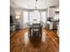 Dining room with bay window, table seating six, wood floors, and white cabinets in the background at 6686 Solana Dr, Castle Pines, CO 80108