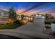 Inviting home exterior with a well-manicured lawn and three-car garage under a colorful sky at 6686 Solana Dr, Castle Pines, CO 80108