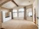 Open living room with high ceilings, large arched windows, carpeted floor, and neutral color scheme at 6686 Solana Dr, Castle Pines, CO 80108