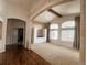 Open living room with high ceilings, large arched windows, carpeted floor, and neutral color scheme at 6686 Solana Dr, Castle Pines, CO 80108