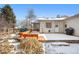 A winter shot of the backyard featuring a deck and patio, perfect for relaxing and entertaining at 13131 Mercury Dr, Lone Tree, CO 80124