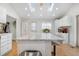 Spacious kitchen island with granite countertops, white cabinets, and skylights provides ample workspace at 13131 Mercury Dr, Lone Tree, CO 80124