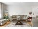 Cozy living room with ample seating, a coffee table, and natural light at 13131 Mercury Dr, Lone Tree, CO 80124