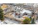 A backyard view with a patio, lovely landscaping, and a privacy fence covered in winter snow at 13131 Mercury Dr, Lone Tree, CO 80124