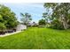 Spacious, well-maintained backyard with a lush lawn, storage shed, and patio seating area at 11886 Birch Dr, Thornton, CO 80233