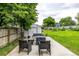 Backyard patio with outdoor seating area, storage shed, green grass and mature trees at 11886 Birch Dr, Thornton, CO 80233