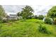 The spacious backyard includes garden boxes, green lawn, and a storage shed at 11886 Birch Dr, Thornton, CO 80233