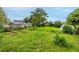 Large backyard with garden beds, a shed, and a mix of wild and manicured green spaces at 11886 Birch Dr, Thornton, CO 80233