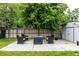 Backyard concrete patio with a seating arrangement around a fire pit with mature trees at 11886 Birch Dr, Thornton, CO 80233