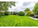 Large backyard with a grass lawn, patio, and seating area at 11886 Birch Dr, Thornton, CO 80233
