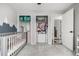 This Bedroom has ample storage options, mountain accent wall, crib, and convenient access to adjacent rooms at 11886 Birch Dr, Thornton, CO 80233