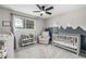Charming Bedroom featuring a mountain-themed mural, ceiling fan, and ample natural light at 11886 Birch Dr, Thornton, CO 80233