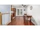 Cozy dining area with hardwood floors and a ceiling fan next to kitchen with white trim french doors to backyard at 11886 Birch Dr, Thornton, CO 80233