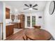 Bright dining area with hardwood floors, ceiling fan, and access to kitchen with oak cabinetry and french patio doors at 11886 Birch Dr, Thornton, CO 80233