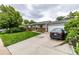 Well-maintained single-story home with brick accents, an attached garage, and a spacious driveway at 11886 Birch Dr, Thornton, CO 80233
