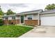 Inviting single-story home with brick accents, gray siding, and a well-manicured front lawn at 11886 Birch Dr, Thornton, CO 80233