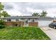 Charming single-story home with brick accents, gray siding, and a well-manicured lawn at 11886 Birch Dr, Thornton, CO 80233