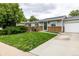 Charming single-story home with brick accents, gray siding, and a neatly landscaped front yard at 11886 Birch Dr, Thornton, CO 80233
