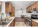 Functional kitchen with oak cabinetry, ample countertop space, and a view through to the dining area at 11886 Birch Dr, Thornton, CO 80233