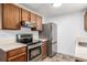 Well-equipped kitchen with stainless steel appliances, oak cabinetry and ample counter space for cooking at 11886 Birch Dr, Thornton, CO 80233