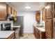 Efficient kitchen featuring stainless steel refrigerator, oak cabinetry, and plenty of counter space at 11886 Birch Dr, Thornton, CO 80233