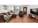 Cozy living room featuring hardwood floors, comfortable seating, and a decorative front door at 11886 Birch Dr, Thornton, CO 80233