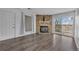 Living room with hardwood floors, stone fireplace, sliding glass doors to balcony, and a large window at 4460 S Pitkin St # 120, Aurora, CO 80015