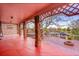 Covered back porch area with a stone support beams, a hot tub, and an outside fire pit at 11157 W Marlowe Ave, Jefferson, CO 80127