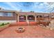 An exterior home view showcasing a brick patio with firepit and lattice details at 11157 W Marlowe Ave, Jefferson, CO 80127